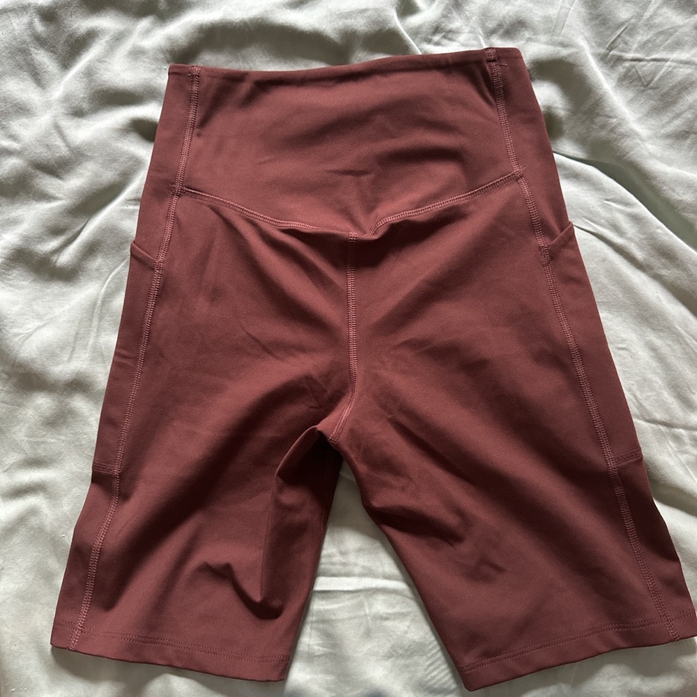 Brown girlfriend collective bike shorts, high waisted. Small, never worn.